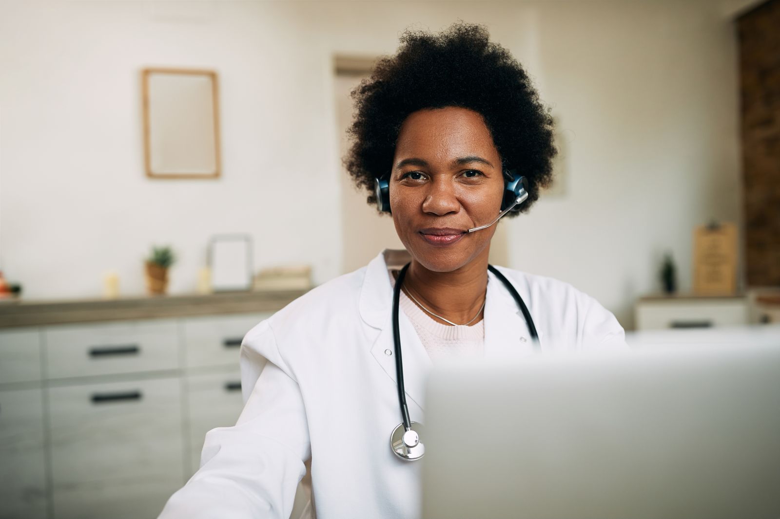 A doctor on a video consultation, wearing a headset