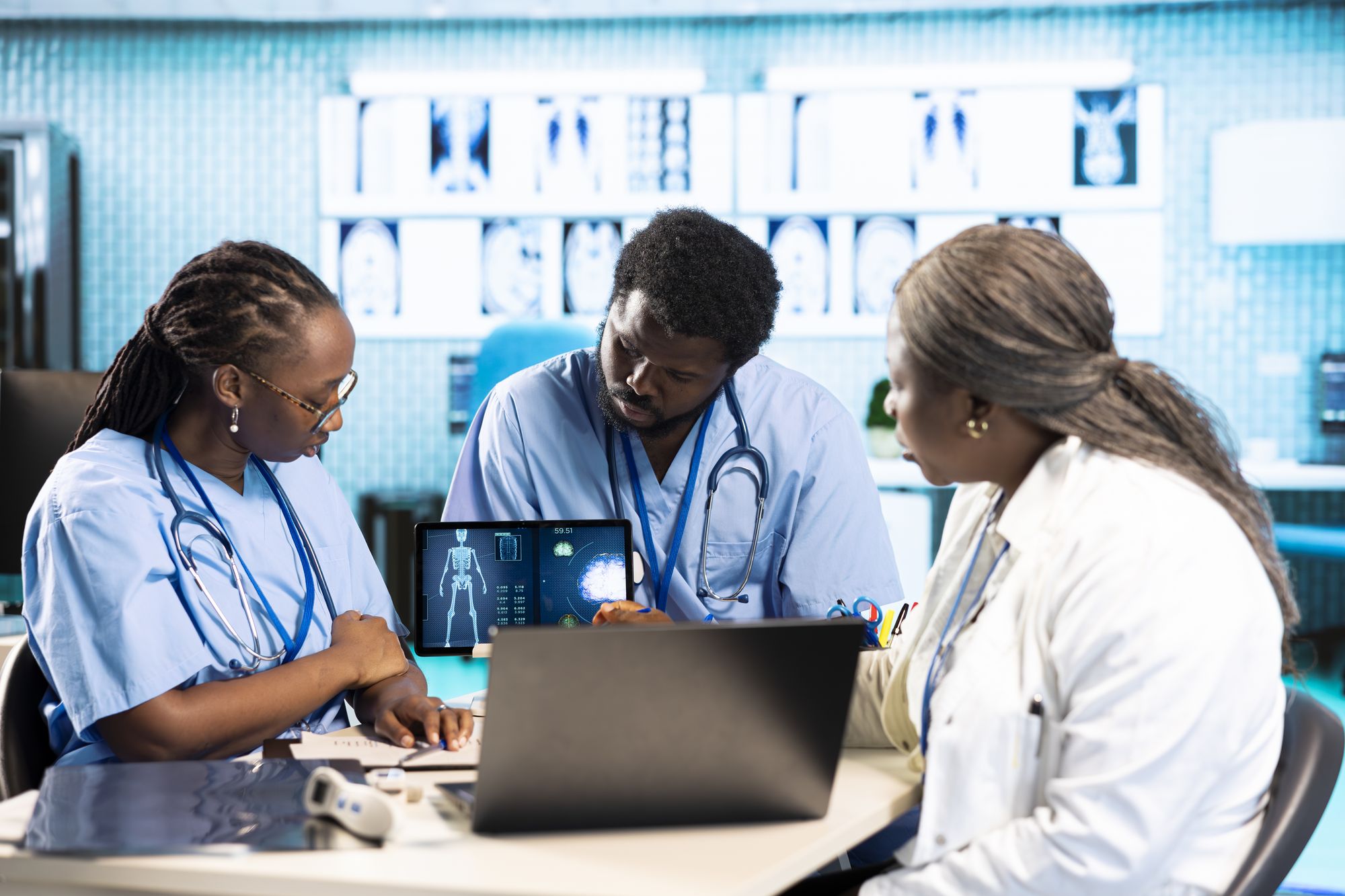 Two nurses and a doctor reviewing results together at a desk