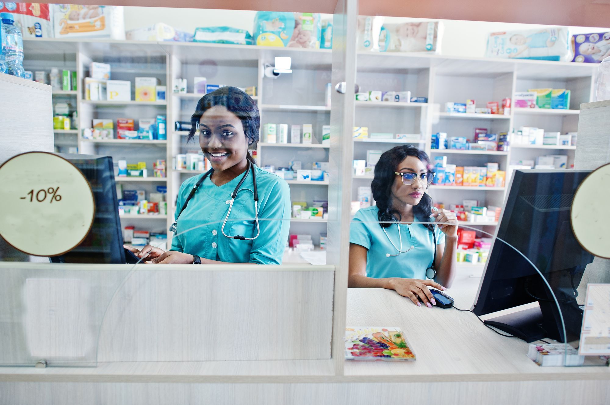 Two pharmacists at a hospital pharmacy counter